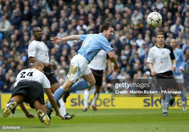 Manchester City's Robbie Fowler heads just wide under a challenge from Fulham's Alain Goma during their Barclaycard Premiership match at the City of...