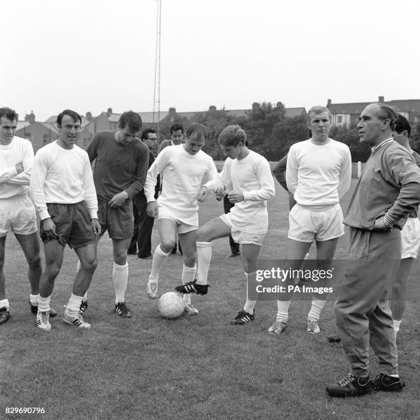 England manager Alf Ramsey prepares to give a team talk as John Connelly, Jimmy Greaves, Geoff Hurst, Ray Wilson, Alan Ball and Bobby Moore wait