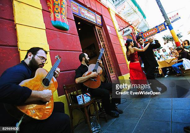 Couple is dancing the traditional dance Tango in front of a restaurant in La Boca district on January 13, 2008 in Buenos Aires, Argentina. The...