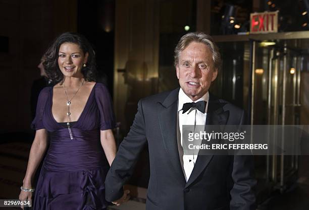 Actors Michael Douglas and his wife Catherine Zeta-Jones arrive to attend an award ceremony during which French President Nicolas Sarkozy will...