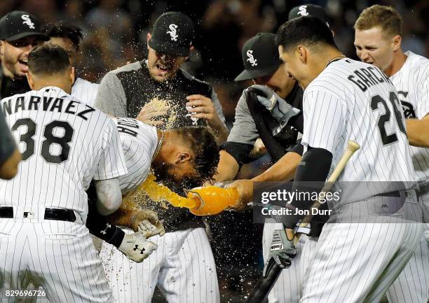 Yoan Moncada of the Chicago White Sox is mobbed by teammates after hitting a walkoff RBI single against the Houston Astros at Guaranteed Rate Field...