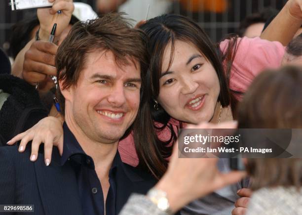 Tom Cruise greets fans as he arrives.