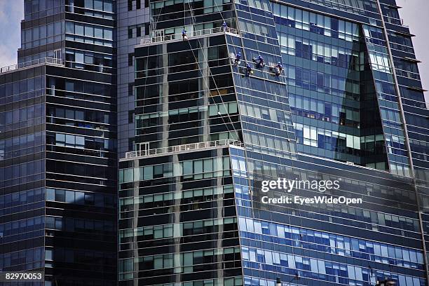 Window cleaner polish windows of a skyscraper in the commercial and financial district on January, 13 in Buenos Aires , Argentina. The Republic of...