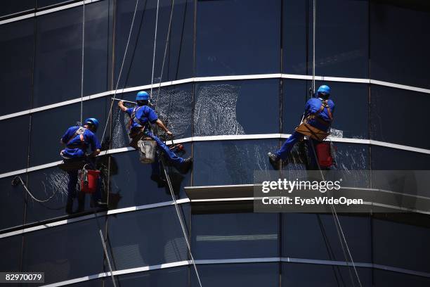 Window cleaners polish windows of a skyscraper in the commercial and financial district on January 13, 2008 in Buenos Aires , Argentina. The Republic...