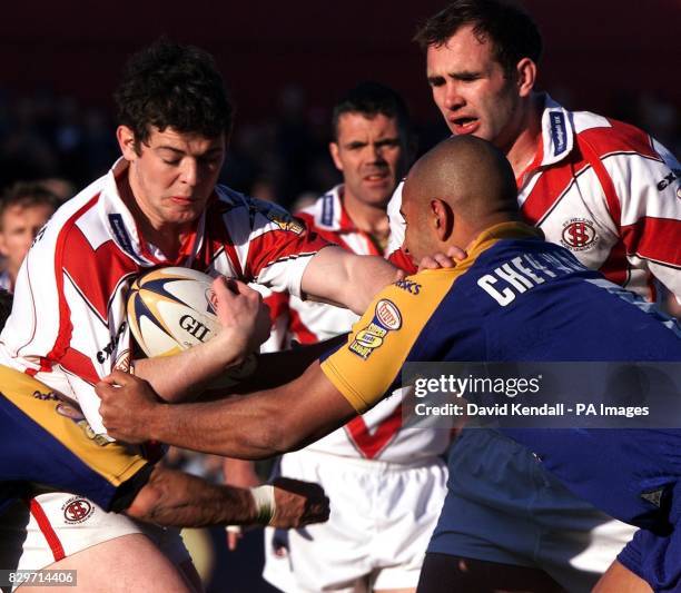 St Helens' Paul Wellens is put under pressure by Leed's Chev Walker as he tries to pass to Chris Joynt, during the Tetley's Bitter Super League game...