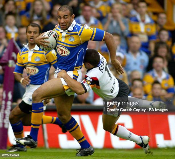 Leeds Rhinos's Chev Walker is tackled by Bradford Bulls's Paul Deacon.