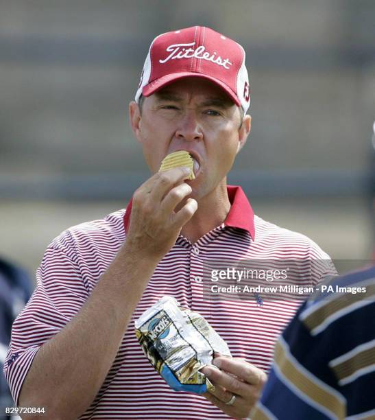 S Davis Love III has a bite to eat prior to teeing off on the first hole during practice.