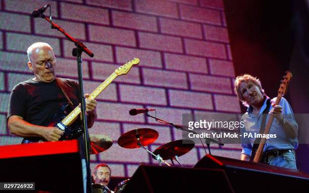Dave Gilmour, Nick Mason and Roger Waters of Pink Floyd performing on stage.