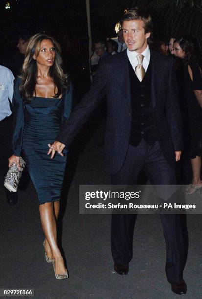 David Beckham and his wife Victoria arrive.