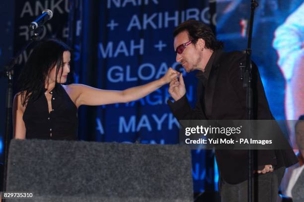 Andrea Corr and Bono perform on stage.