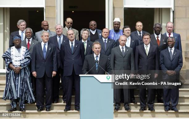 Leaders pose for a family photo at the end of the G8 summit in Gleneagles. Front row L to R: Nigerian President Olusegun Obasanjo, U.S. President...