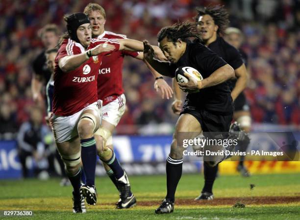 New Zealand captain Tana Umaga hands off Lions' Ryan Jones.