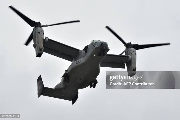 This photograph taken on April 18, 2016 shows a US Marine tilt-rotor Osprey aircraft landing at an emergency helicopter landing site in Minami-Aso,...
