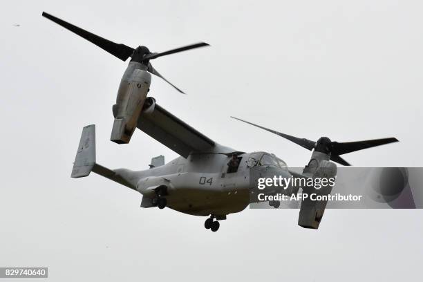 This photograph taken on April 18, 2016 shows a US Marine tilt-rotor Osprey aircraft landing at an emergency helicopter landing site in Minami-Aso,...