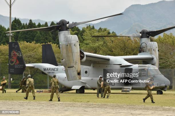 This photograph taken on April 18, 2016 shows a US Marine tilt-rotor Osprey aircraft at an emergency helicopter landing site in Minami-Aso, Kumamoto...