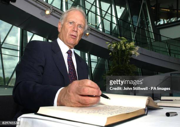 The Australian High Commissioner Richard Alston signs the Book of Condolences for the victims of last week's terror blasts, at the London City Hall...