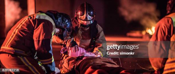 injured firefighter - fireman uniform stock pictures, royalty-free photos & images