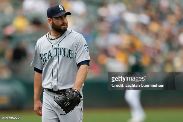 Tony Zych of the Seattle Mariners walks back to the dugout after pitching in the eighth inning against the Oakland Athletics at Oakland Alameda...