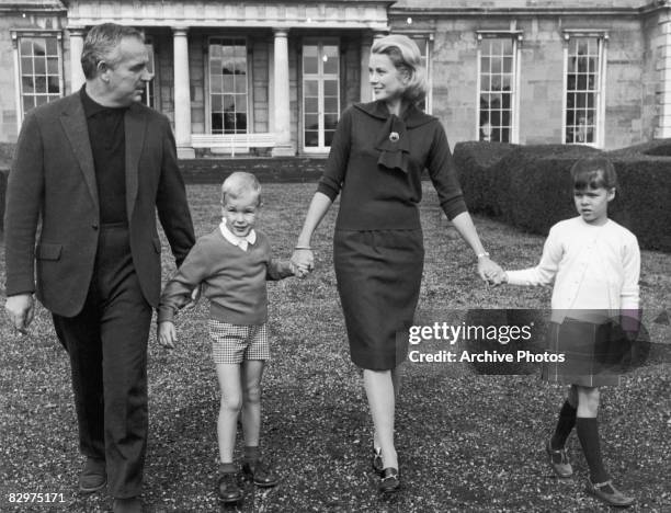 American actor Grace Kelly on a driveway in front of a ranch-style house near Palm Springs, Florida, with her husband Prince Rainier III of Monaco...