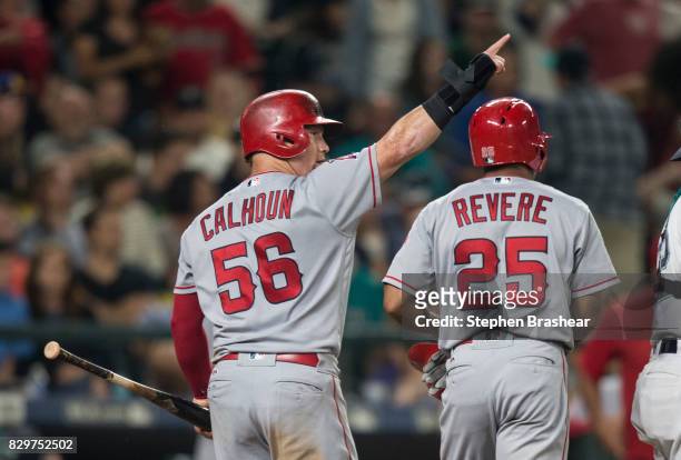 Kole Calhoun of the Los Angeles Angels of Anaheim gestures to Mike Trout of the Los Angeles Angels of Anaheim on second base after Trout hit a...