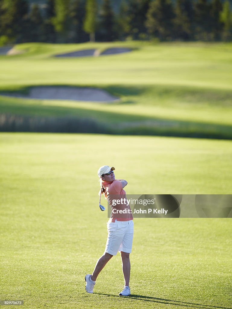 Young woman playing golf