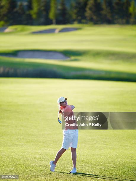 young woman playing golf - women golf ストックフォトと画像