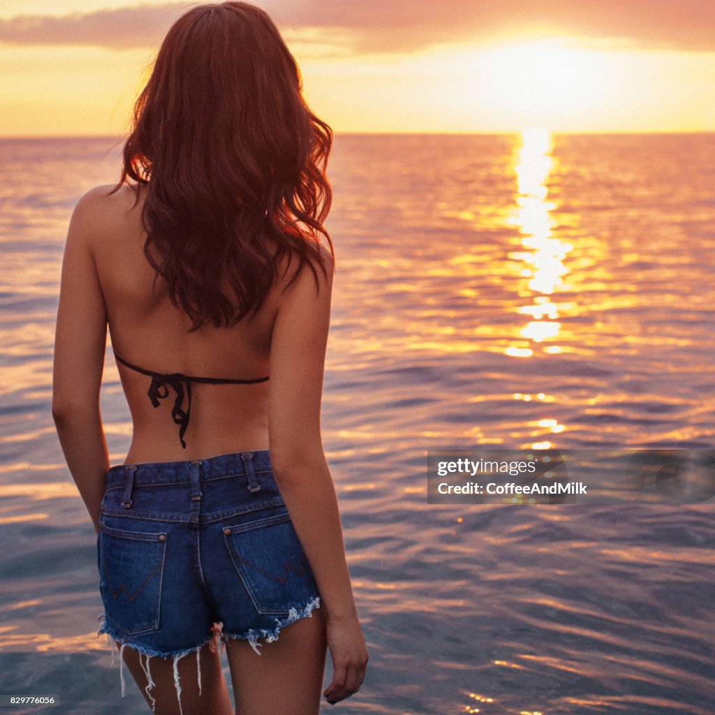 Schöne Frau genießt Sonne am Strand