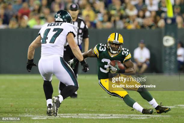 Green Bay Packers running back Aaron Jones tries to evade Philadelphia Eagles linebacker Nate Gerry during a football game between the Green Bay...