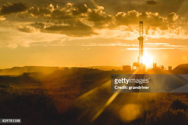 fracking drilling rig at the golden hour - mineral stock pictures, royalty-free photos & images
