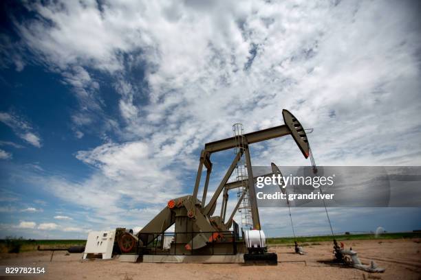 fracking pumpjacks in the oil field - oil pump stock pictures, royalty-free photos & images