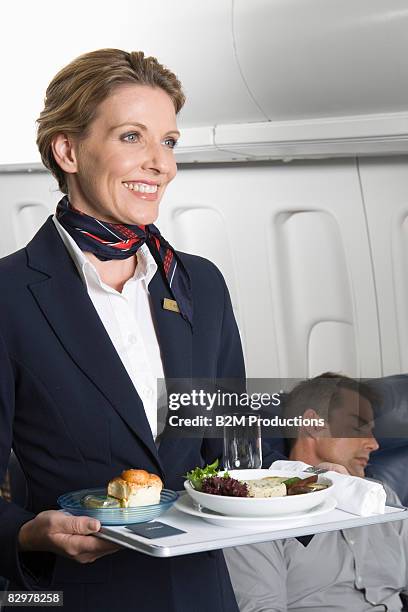 airline stewardess holding tray - plane food stock pictures, royalty-free photos & images