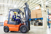 worker driving a forklift in warehouse