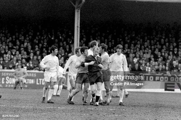 Referee Ray Tinkler is pulled away from furious Leeds United players Johnny Giles , Billy Bremner , Jack Charlton and Allan Clarke after allowing...