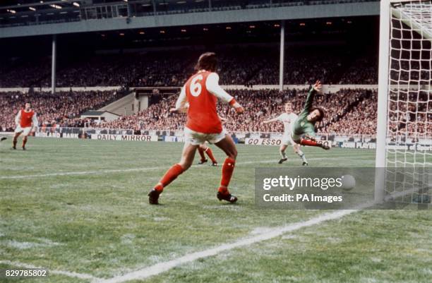 Arsenal goalkeeper Geoff Barnett dives in vain as Leeds United's winning goal flies into the net, watched by teammate Peter Simpson and Leeds...