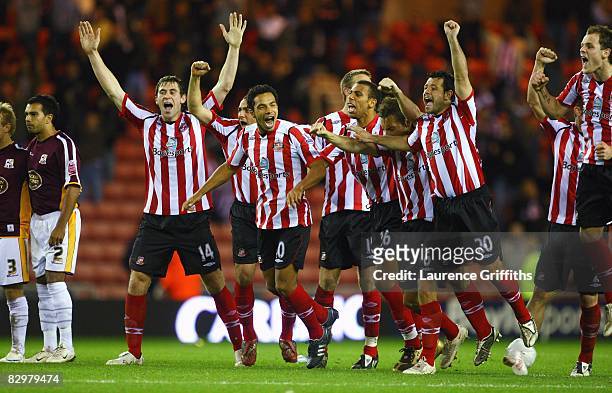Sunderland players celebrate victory on penalties after 2the Carling Cup Third Round match between Sunderland and Northampton Town at the Stadium of...