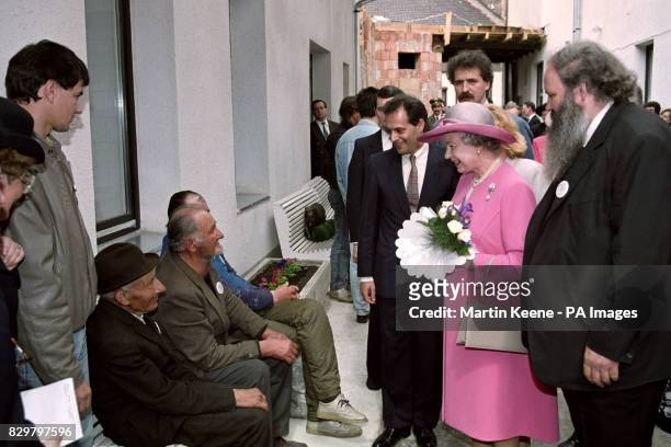 BRITAIN'S QUEEN ELIZABETH II TALKS TO HOMELESS HUNGARIANS DURING A VISIT TO A WESLEYIAN HOSTEL WHICH PROVIDES NIGHTIME SHELTER TO 50 MEN IN BUDAPEST....