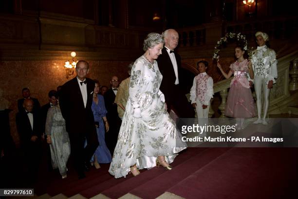 Queen Elizabeth II walks up the steps inside Hungary's National Opera House in Budapest with the Minister for Education and Science, Dr Ference Madl,...