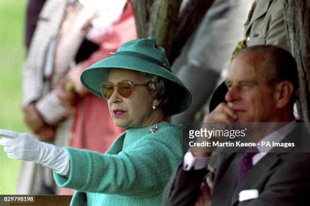 WE ARE AMUSED ...BRITAIN'S QUEEN ELIZABETH II LAUGHS AS SHE WATCHES A DISPLAY OF TRADITIONAL SKILLS BY HUNGARIAN HORSEMEN ON THE PLAINS AT BUGAC. THE...