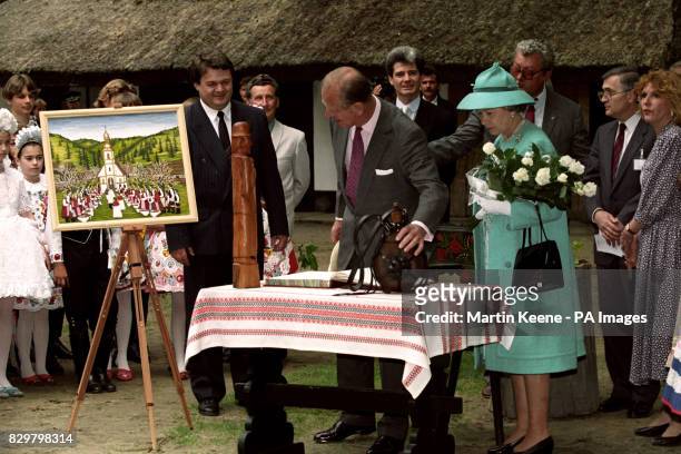 THE QUEEN AND THE DUKE OF EDINBURGH INSPECT SOME OF THE HUNGARIAN ARTIFACTS DURING THEIR VISIT TO BUGAC ON THE HUNGARIAN PLAINS ON THE THIRD DAY OF...