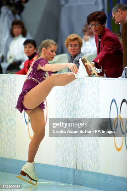 TONYA HARDING SHOWS THE JUDGES HER SKATES DURING THE FREE SKATING PROGRAMME IN HAMAR. HER LACE HAD BROKEN BEFORE GOING ON AND A SHORT LACE LEFT THE...