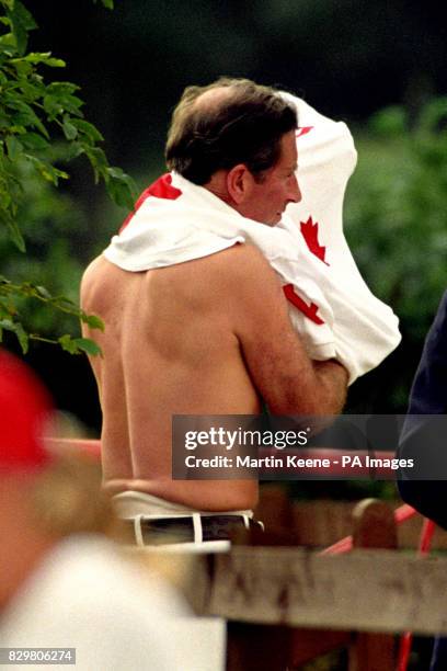 PRINCE CHARLES PUTS ON HIS SHIRT BEFORE PARTICIPATING IN A CHARITY POLO MATCH AT ANSTEY, IN AID OF THE LEONORA CANCER FUND, WHICH WAS FOUNDED IN...