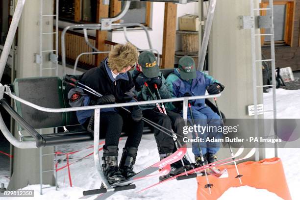 THE PRINCESS OF WALES AND HER SONS PRINCE WILLIAM AND PRINCE HARRY [R] HIDE FROM PHOTOGRAPHERS AS THEY TAKE THE FIRST CHAIR LIFT ON THE SECOND DAY OF...