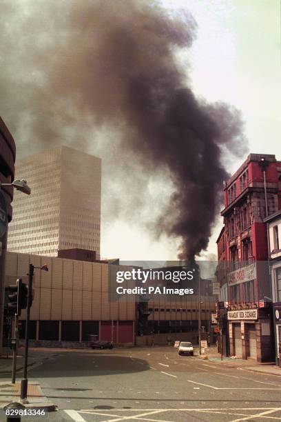 Smoke rises in the centre of Manchester after a huge explosion in the city.