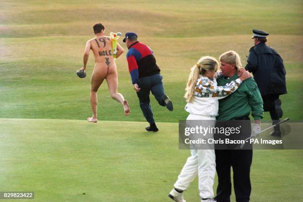 John Daly celebrates with his wife Paulette, after clinching the Open after beating Costantino Rocca in tonight's play-off, as a streaker runs onto...