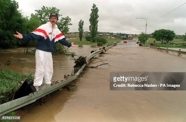 England's Jack Russell surveys the flooded road which was closed today , next to the Centurion Park cricket ground. Russell is waiting to bat after...