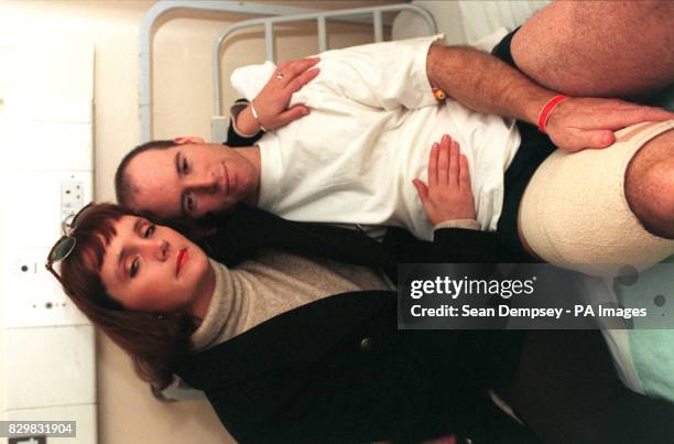 Karen Fitzpatrick comforts her husband, Pc Anthony Fitzpatrick, in King's College Hospital, London, this morning after he was shot in the thigh by a...