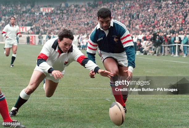 England's Rory Underwood followed by Emiel Ntamack goes to score a try that was not allowed in the first half of the France v England Five Nations...