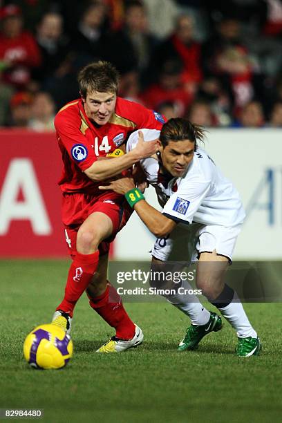Scott Jamieson of Adelaide fights for the ball against Marquinhos of Kashima during the ASL Quarter Final match between Adelaide United and Kashima...