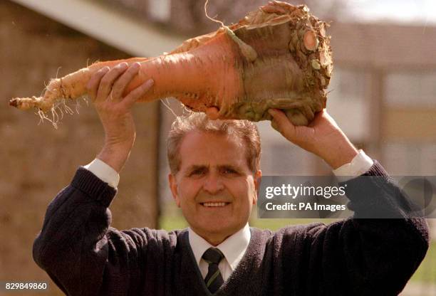 Bernard Lavery from Spalding, Lincolnshire, stakes his claim for a world record with a carrot weighing in at 7.095 kg. Mr Lavery holds 15 world...