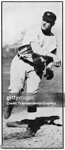 In the Polo Grounds in New York, Giants pitcher Christy Mathewson warms up on the mound before a National League game.